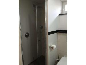 a shower stall in a bathroom with a toilet at One-bedroom apartment in Bernshausen