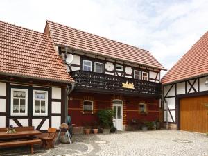 a group of buildings with a bench in a courtyard at One-bedroom apartment in Bernshausen