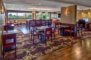 a restaurant with tables and chairs and a bar at Hampton Inn Corinth in Corinth