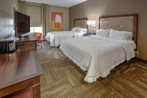 a hotel room with two beds and a flat screen tv at Hampton Inn Corinth in Corinth +27 photos