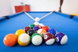 a group of billiard balls on a pool table at Fare Tehaikinoa Teahupo'o in Teahupoo