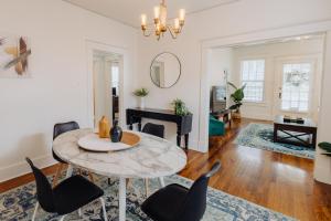 a living room with a table and chairs and a piano at Historic Revival 2BR Midtown Memphis Fast Wifi Free Parking Yes Pets in Memphis