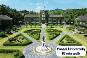a building with a fountain in the middle of a garden at Hongdae Sinchon Skyview in Seoul