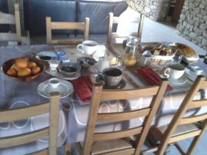 a dining room table with a plate of food on it at Chambre d'hôte dans ferme rénovée - Nature et confort avec parking - FR-1-591-677 in Thevet-Saint-Julien +10 photos