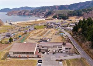 an aerial view of a building next to the water at 三陸アクティブ in Ōfunato