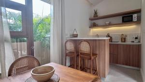 a kitchen with a table and some chairs and a counter at Villa Sun, Villa 19 in Chaweng Noi Beach