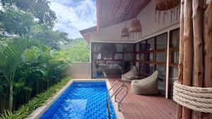a house with a swimming pool on a deck at Villa Sun, Villa 19 in Chaweng Noi Beach