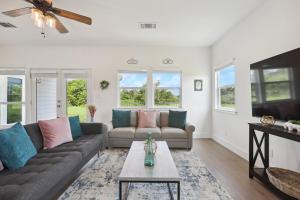 a living room with a couch and a tv at Modern Farmhouse in McDade in McDade