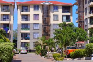 a building with cars parked in front of it at Bliss Park B & B in Athi River