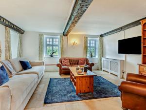 a living room with a couch and a table at 5 Bed in Watchet 95371 in Bicknoller