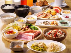 a table with many plates of food on it at Nishitetsu Resort Inn Naha in Naha +73 photos