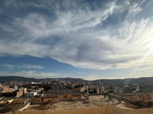 a view of a city from the roof of a building at Hotel el bahia tlemcen in Tlemcen
