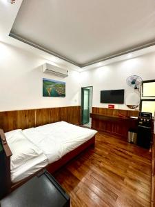 a bedroom with a bed and a flat screen tv at Mây Homestay in Quy Nhon
