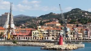 a city with a red lighthouse in the water at Cà Mea in Imperia