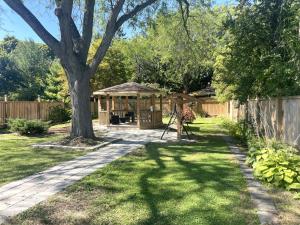 a backyard with a gazebo and a tree at Cozy Home in Niagara-on-the-Lake in Niagara on the Lake