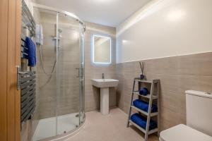 a bathroom with a shower toilet and a sink at Hide Away in Berwick-Upon-Tweed +9 photos