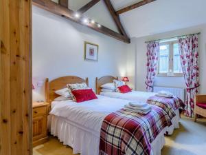 a bedroom with two beds and a window at 3 bed in York 83264 in High Catton