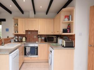 a kitchen with wooden cabinets and white appliances at 2 Bed in St Agnes 50085 in St. Agnes 