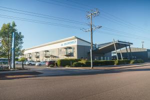 a large building on a street with cars parked outside at MainStay Suites Whyalla in Whyalla