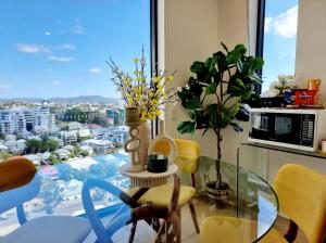 a dining room with a glass table and a window at Premium City Escape-Stunning Skyline Views in Brisbane