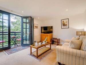 a living room with a couch and a table at 3 Bed in Lostwithiel 93041 in Lostwithiel