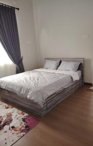 a bedroom with a large bed in a room at MA Homestay Kuala Nerus, Kuala Terengganu in Kuala Terengganu +1 photo