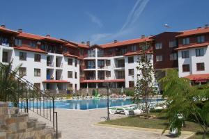 a hotel with a swimming pool in front of a building at Complex Apolon in Nesebar