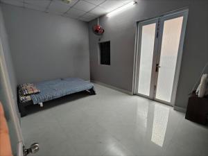 a bedroom with a bed in a room with a window at Cay Bang Homestay in Long Hai