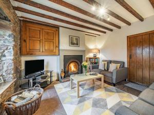 a living room with a couch and a fireplace at 2 Bed in Wasdale SZ436 in Santon Bridge