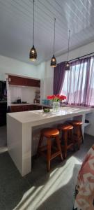 a kitchen with a large white table and some chairs at Villa Casablanca in Montongbuwoh