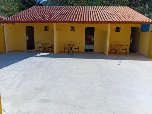 a yellow building with tables and chairs in front of it at Pousada Araújo em Paraty 1 in Paraty