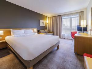 a large white bed in a hotel room at Novotel Southampton in Southampton +106 photos