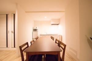 a dining room with a long table and chairs at SEVEN Building / Vacation STAY 4949 in Asahikawa