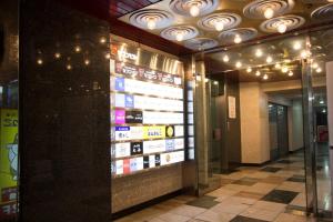 a lobby of a building with a sign on the wall at SEVEN Building / Vacation STAY 4949 in Asahikawa