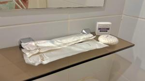 a shelf in a bathroom with a thermometer on it at Serene Haven with Skyline View in Sampong