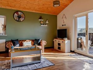 a living room with a couch and a tv at 2 Bed in Sidmouth 91118 in Ottery Saint Mary