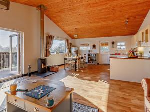 a kitchen and living room with a wooden ceiling at 2 Bed in Sidmouth 91118 in Ottery Saint Mary