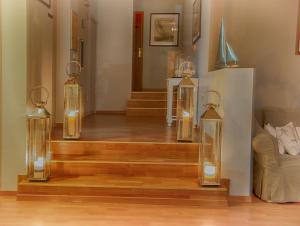 a stairway with four glass containers with candles on it at Hotel Santa Maria in Saint-Florent