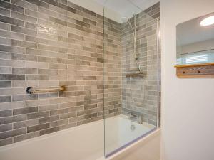 a bathroom with a shower and a bath tub at 2 Bed in Kielder 79240 in Falstone +33 photos