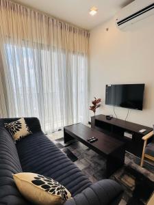 a living room with a couch and a flat screen tv at Trizen luxury apartments Colombo Sri lanka in Colombo