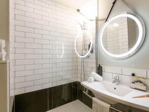 a bathroom with a sink and a mirror at ibis Gap Centre in Gap