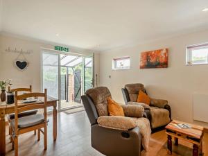 a living room with a couch and a table at 1 Bed in Brundall 46293 in Brundall