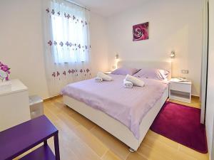a bedroom with a large bed with two towels on it at Apartments Garden Residence in Opatija