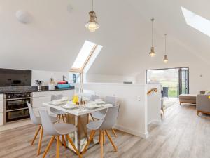 a kitchen and dining room with a table and chairs at 3 Bed in Westward Ho 48389 in Northam