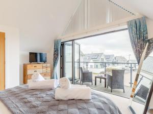 a bedroom with a bed and a large window at 3 Bed in Westward Ho 52930 in Northam