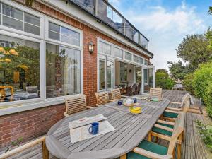 a wooden table and chairs on a patio at 2 Bed in Bexhill-on-sea 95831 in Bexhill