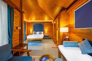 a bedroom with a bed in a wooden room at Sterling Kadumane Hills Sakleshpur in Sakleshpur
