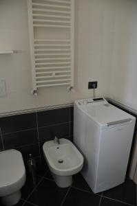 a white toilet and a sink in a bathroom at Villaggio La Piana in Cervo