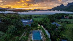 an aerial view of a resort with a swimming pool at Sundara Hoà Bình Retreat in Hòa Bình +60 photos