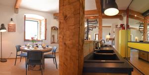 a kitchen and dining room with a table in a room at Villae Dalmaticae - Plava in Sumartin